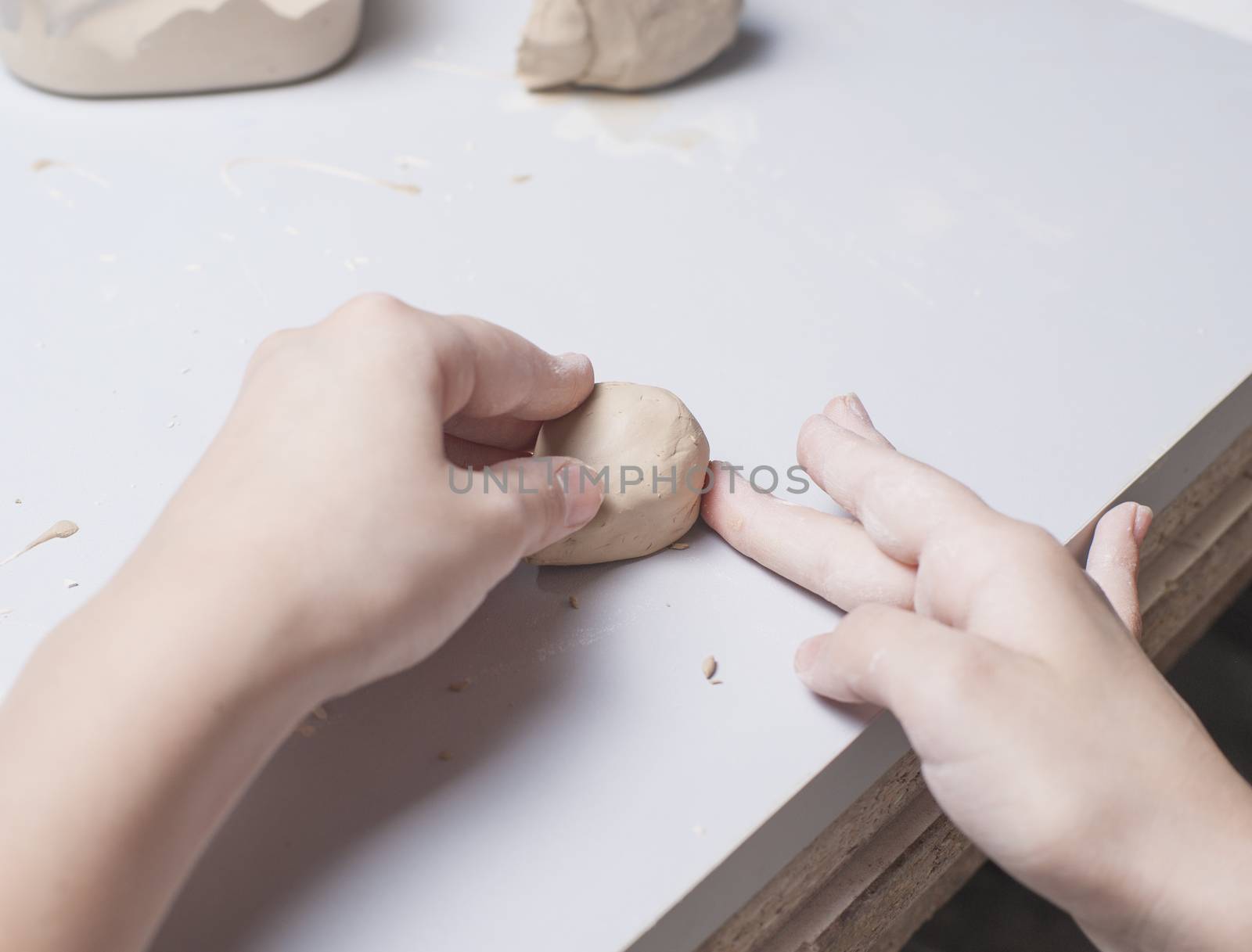 Girl make toyfrom clay. High resolution image.