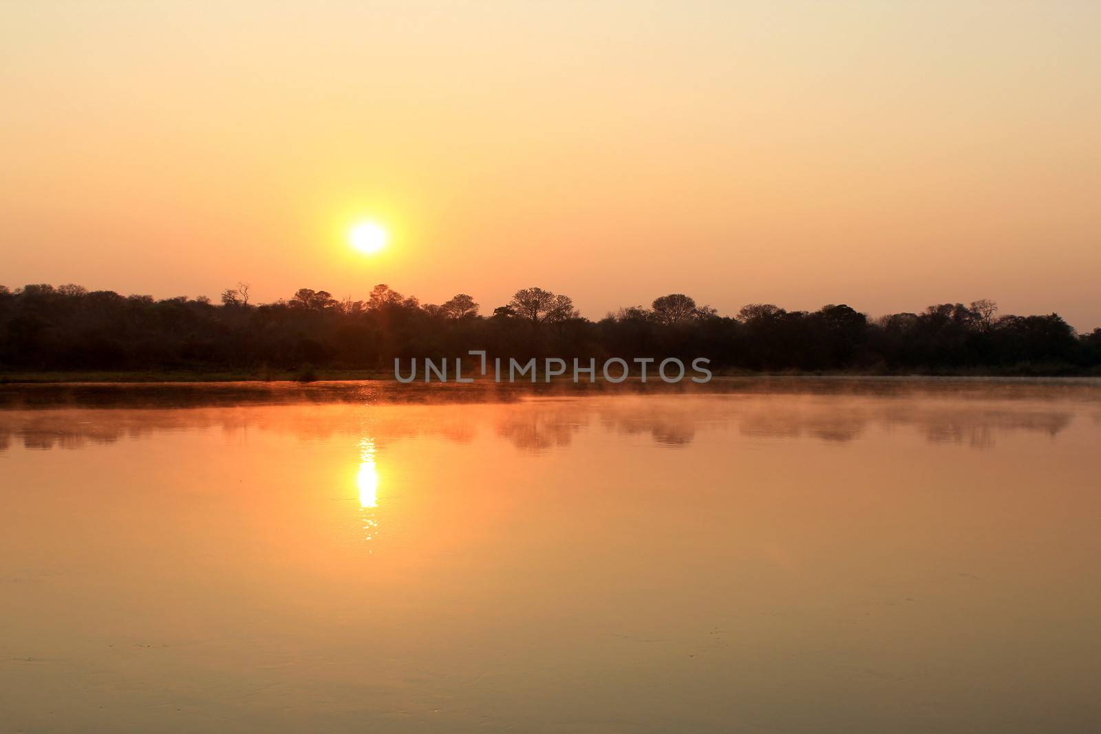 Sunrise at Kavango river whit mist on the water surface, Caprivi region. Namibia