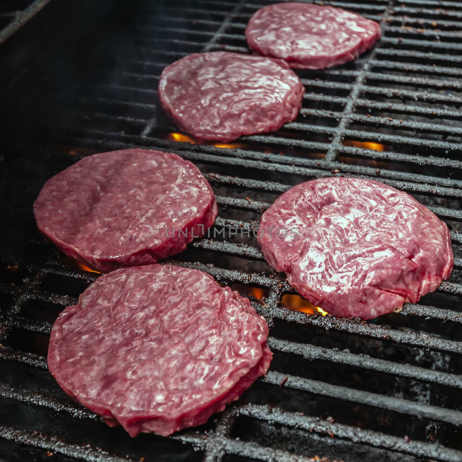 Photograph of   tasty beef burgers on the grill