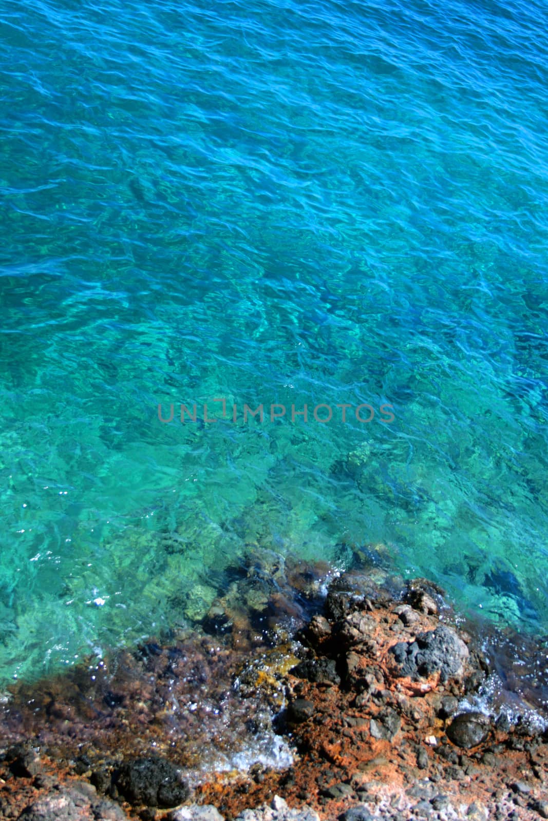 A rocky sea shore with beautiful blue clean water.