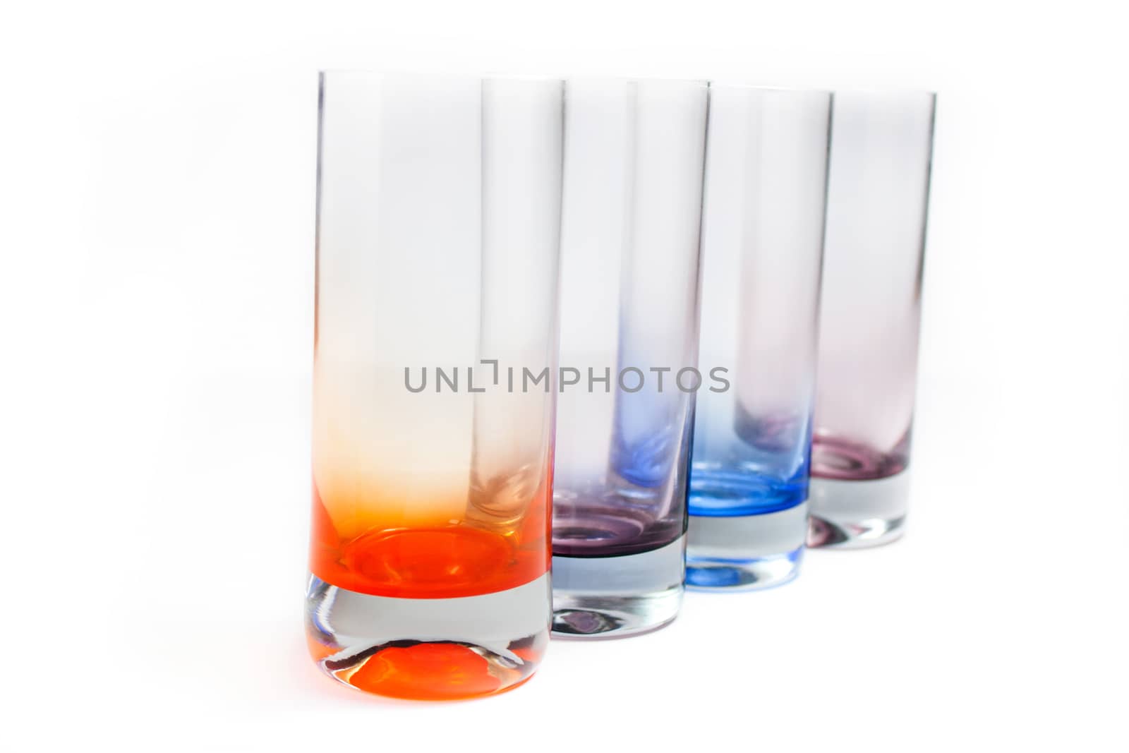 Four brightly colored beverage glasses close-up