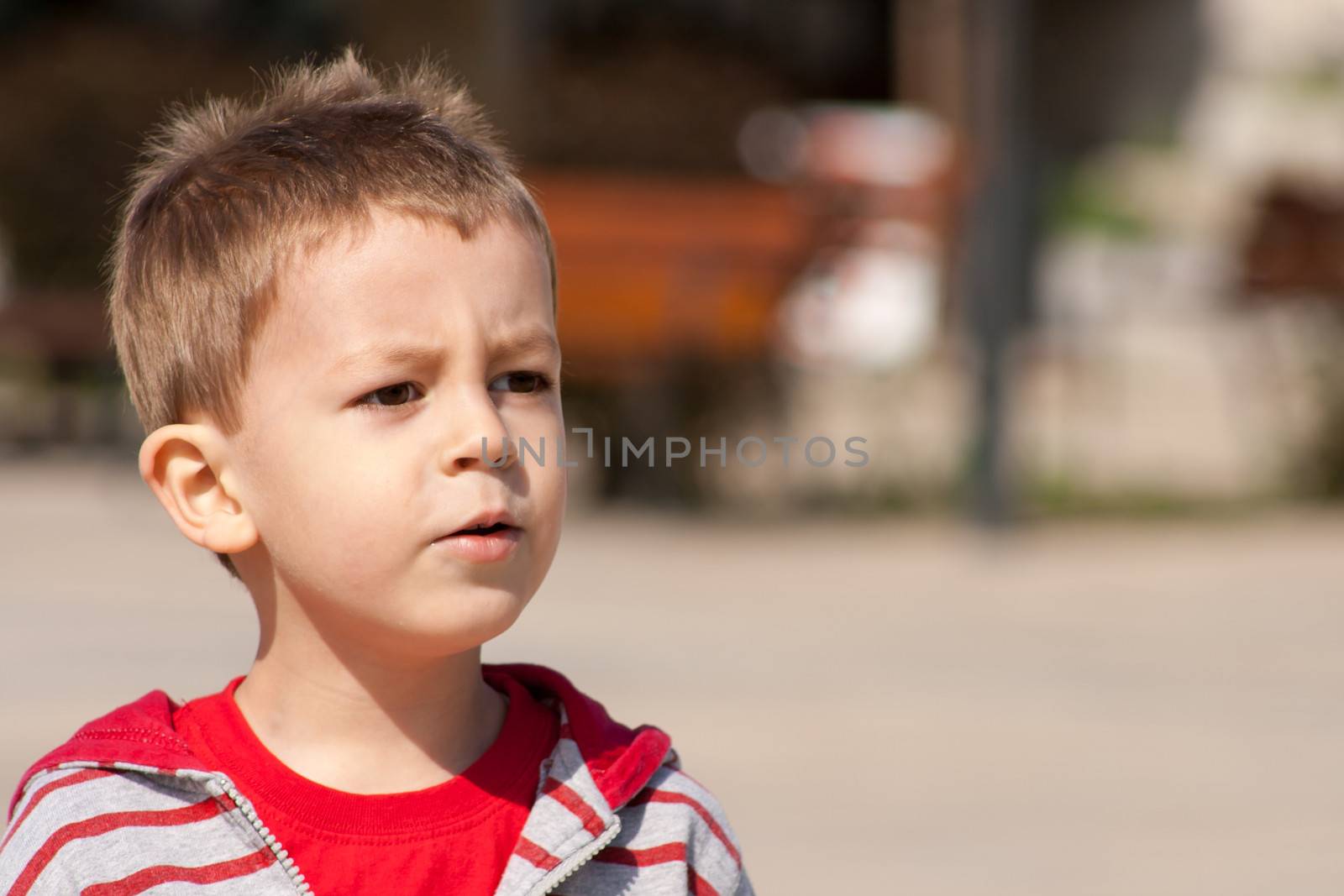 Child thinks while posing for camera