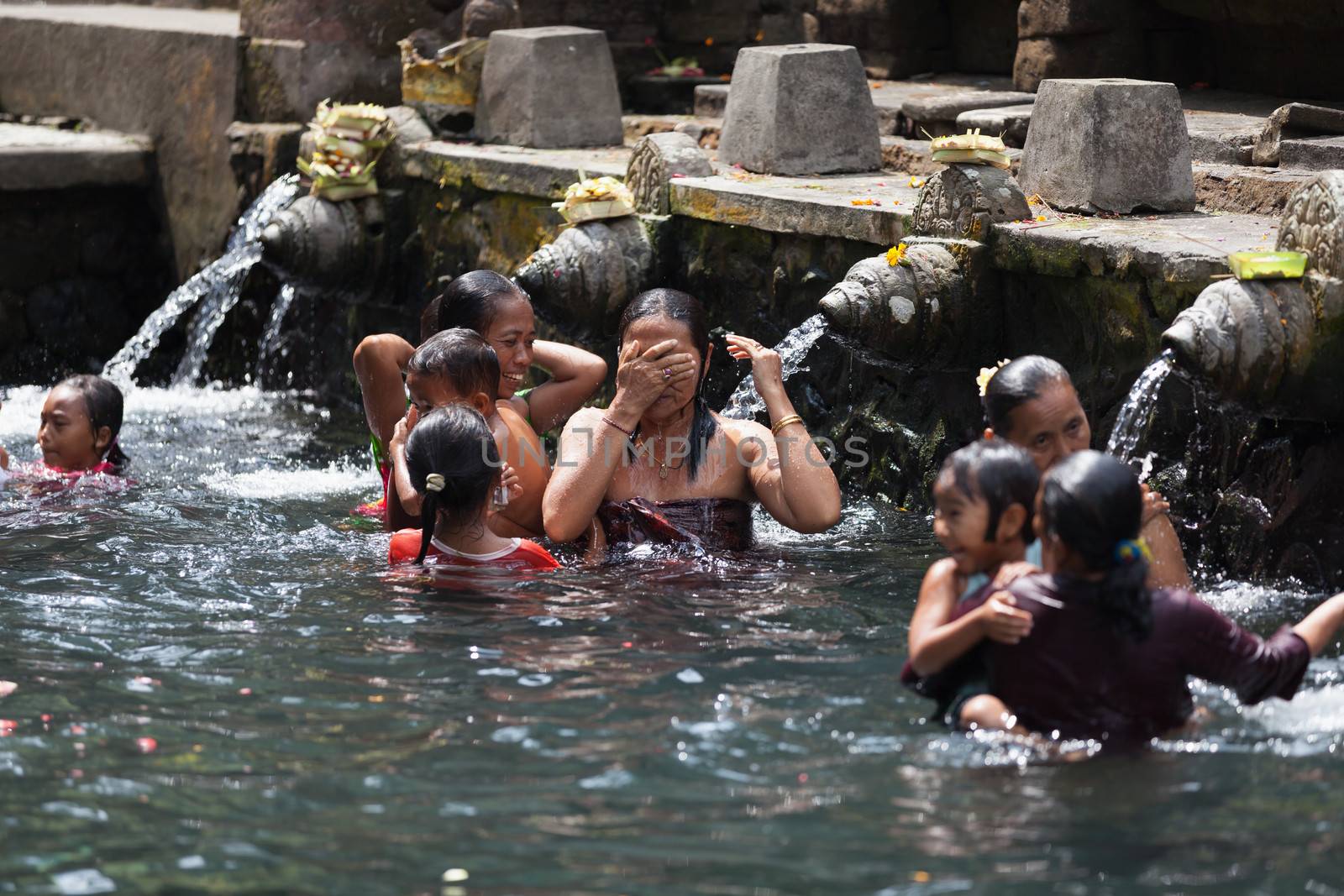 Purification in sacred holy spring water, Bali by iryna_rasko