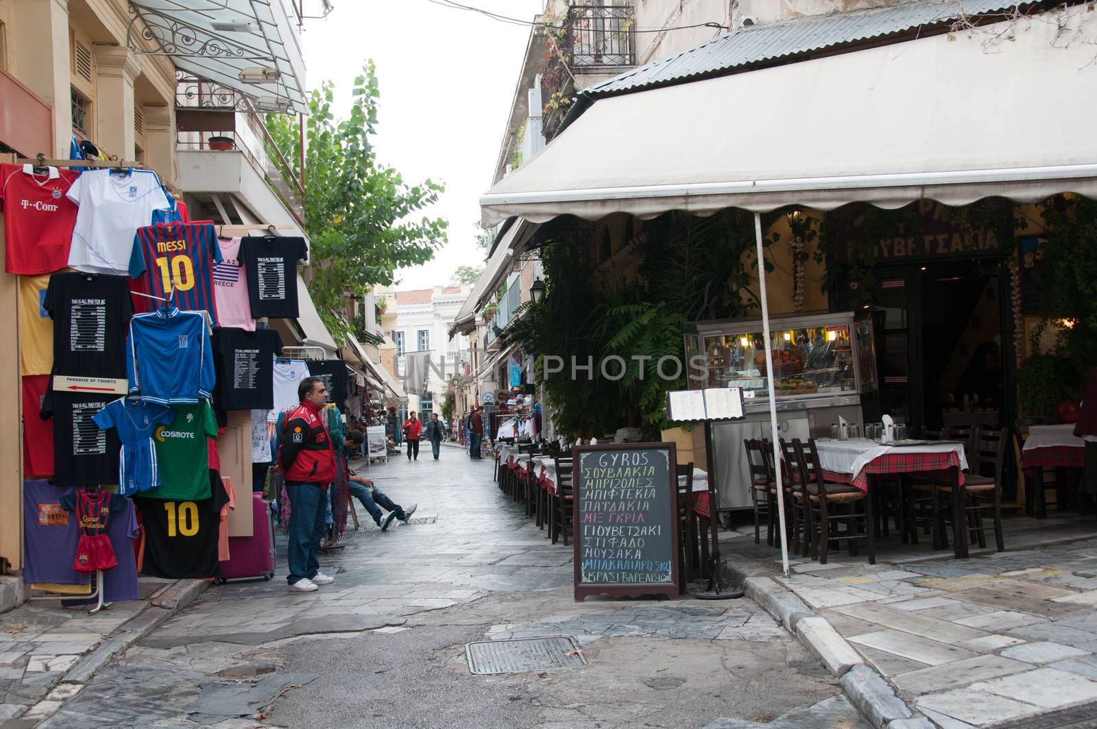 ATHENS GREECE - 15 OCTOBER 2011: Athens narrow street with shops and restaurants, old town - Plaka