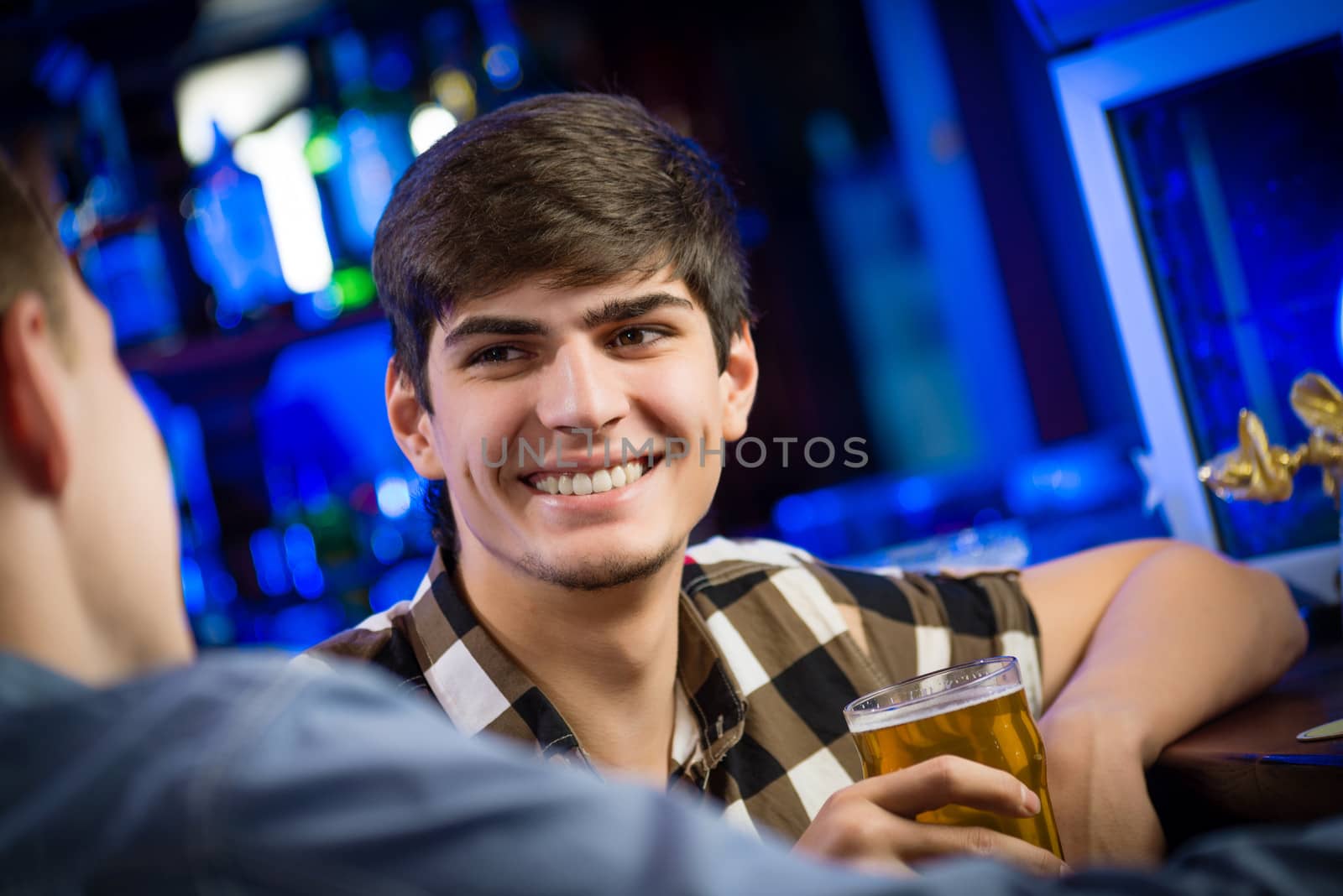 portrait of a young man at the bar, fun nightlife