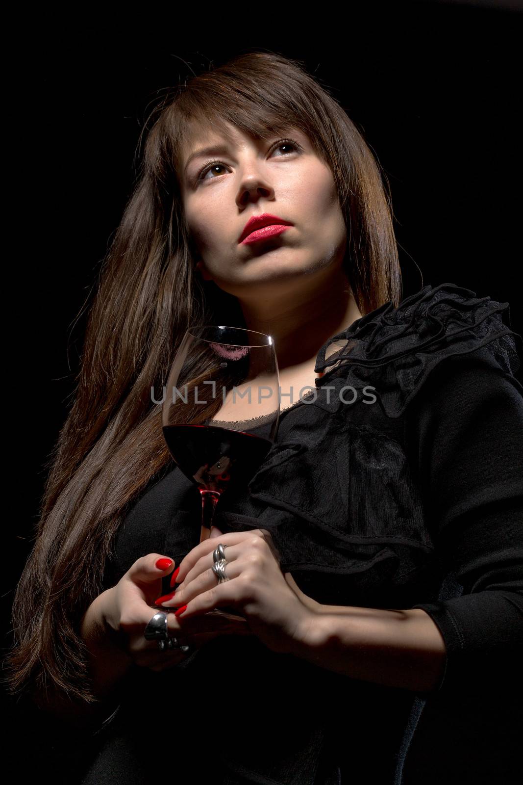 Young woman with red wine from a glass by Discovod