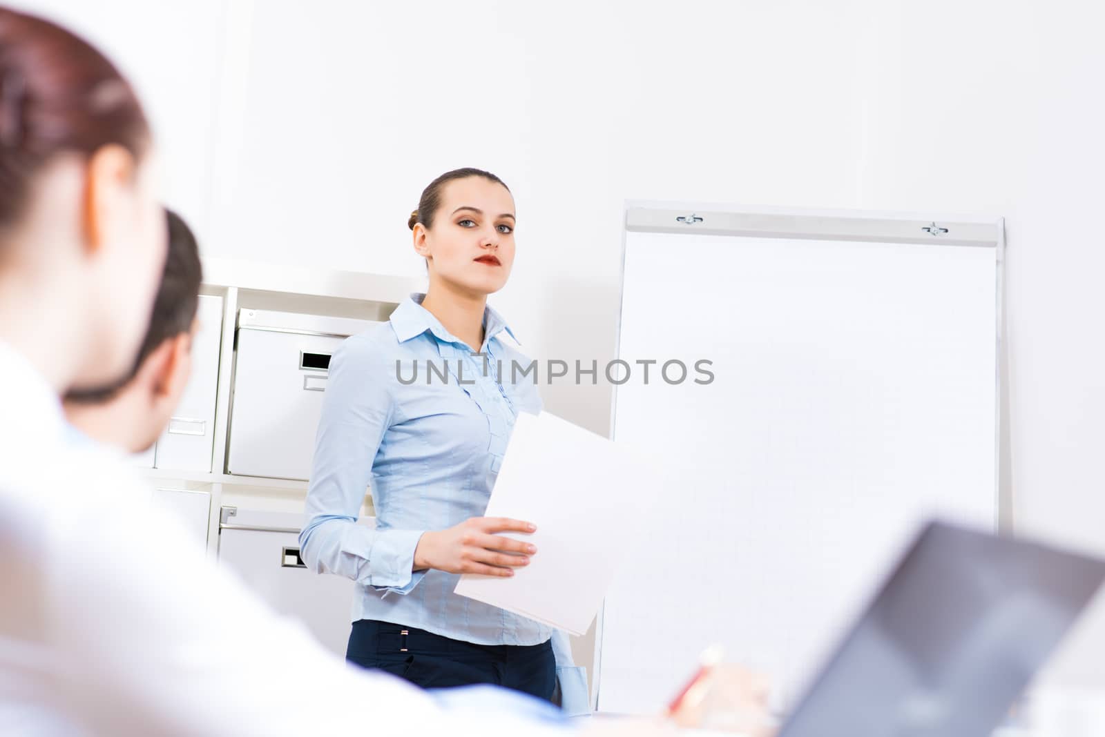 business woman doing a report next presentation boards, listening to her colleagues