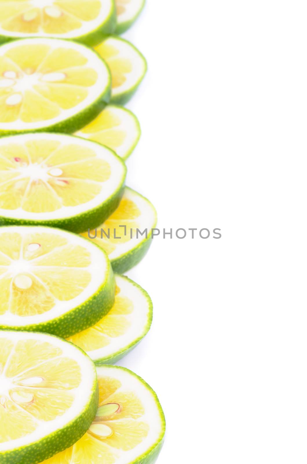 Frame of Ripe Green Lemon Slices closeup on white background