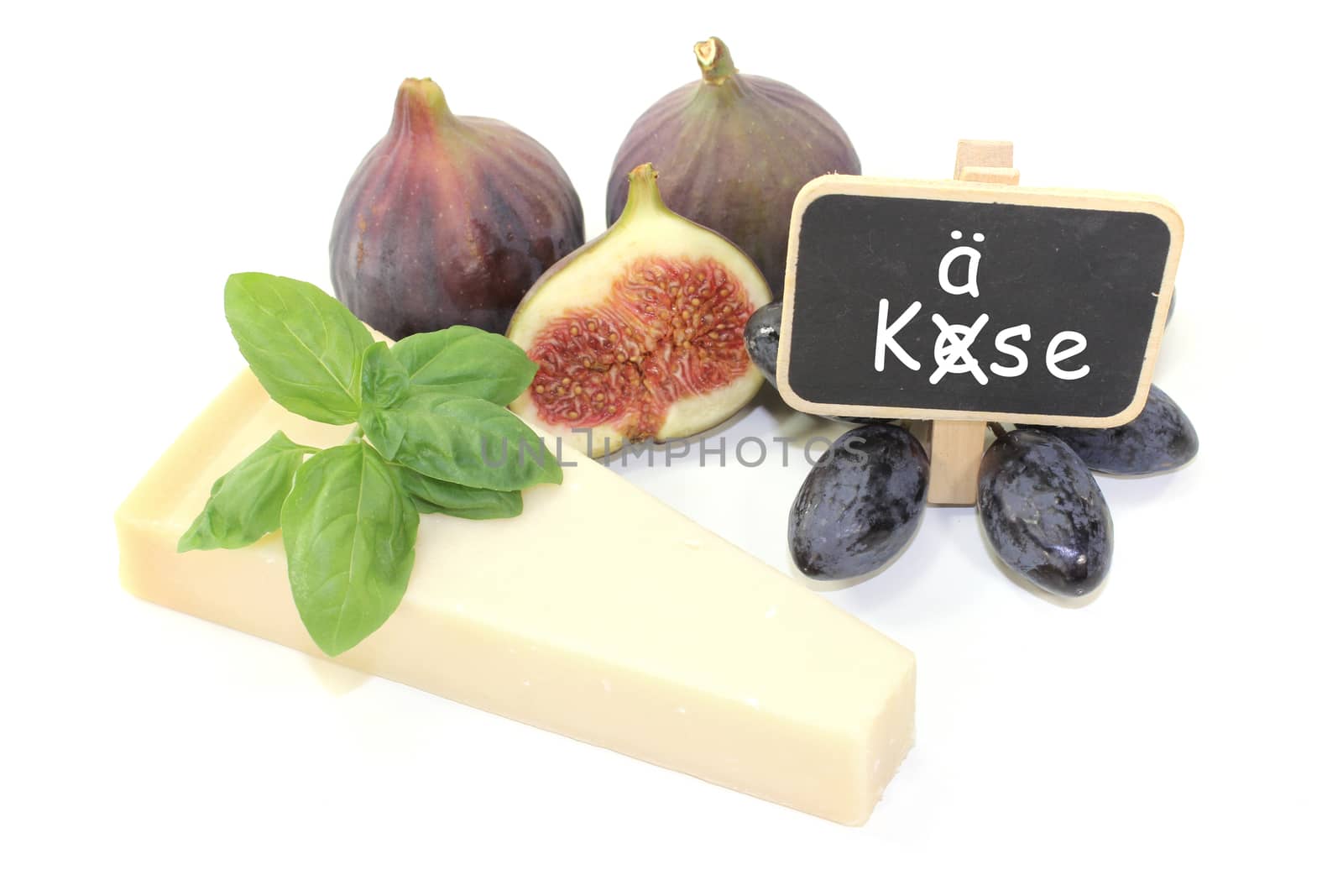 Parmesan cheese with figs, grapes, basil and blackboard