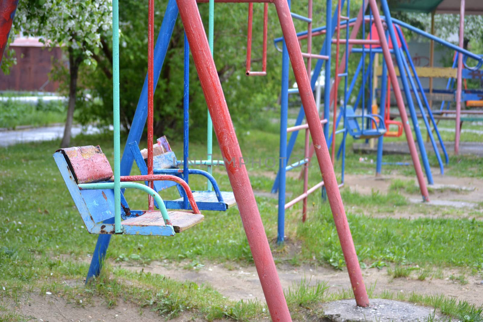 empty children's swing in a yard