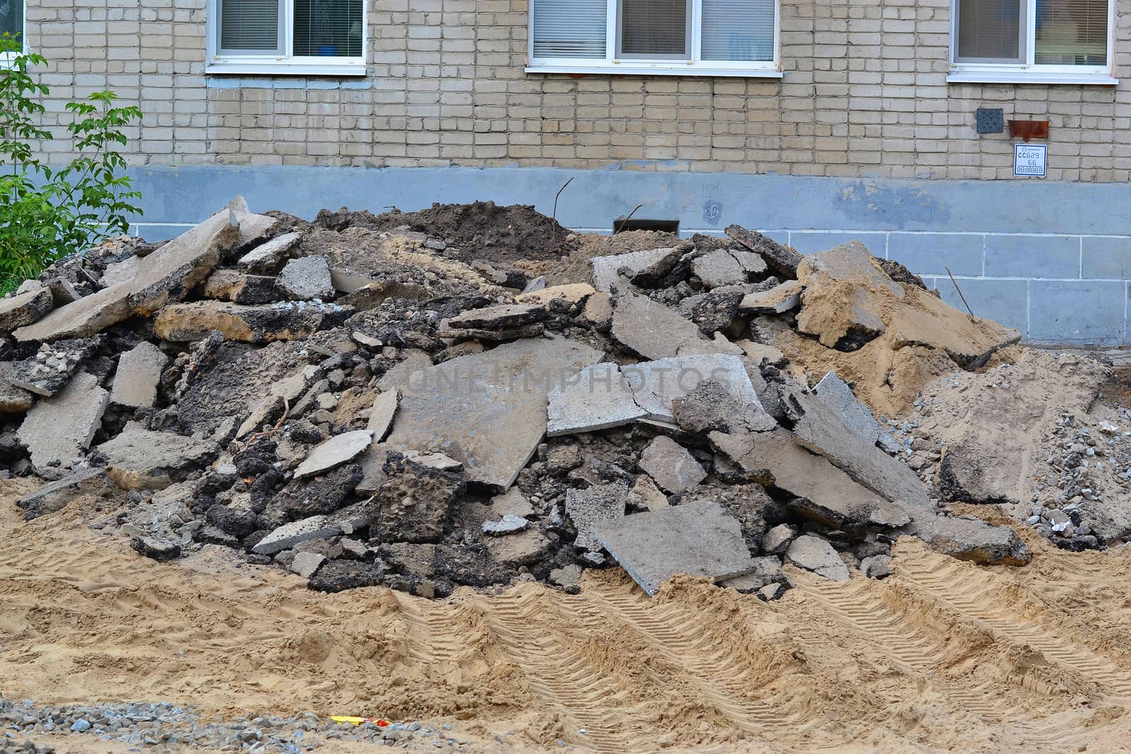 Pieces of old asphalt before a house