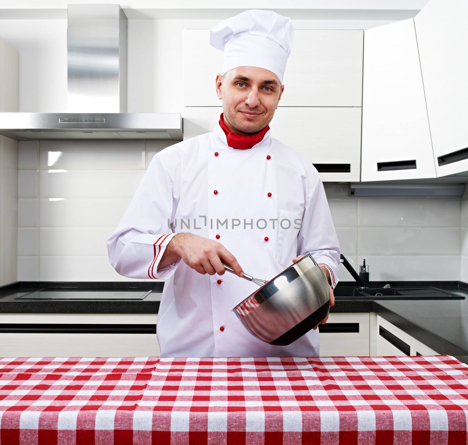 Male chef at kitchen getting ready to cook