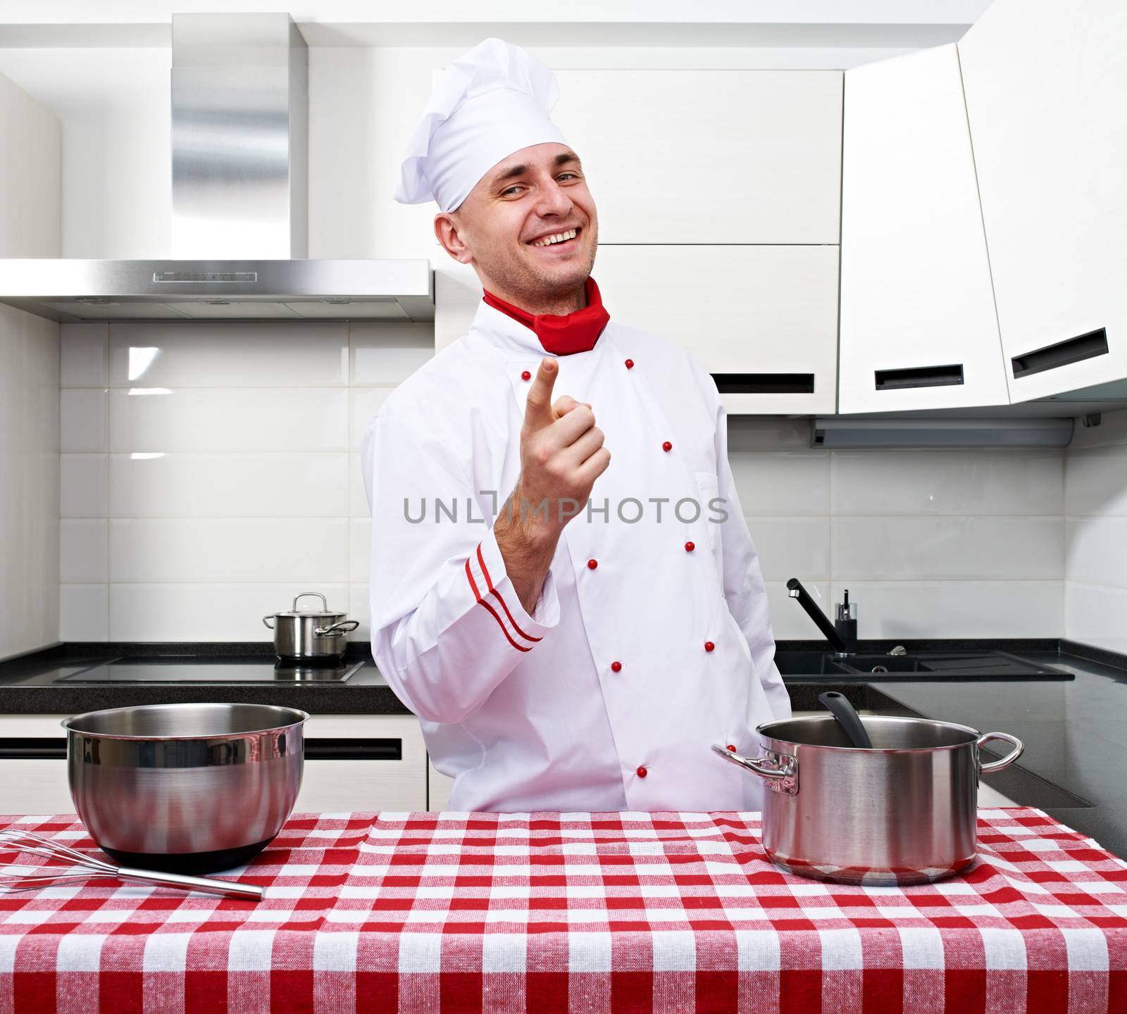 Male chef at kitchen getting ready to cook