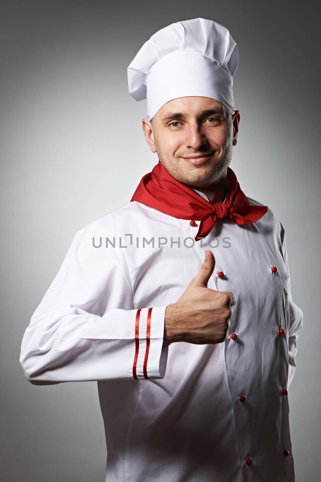 Male chef with thumb up portrait against grey background