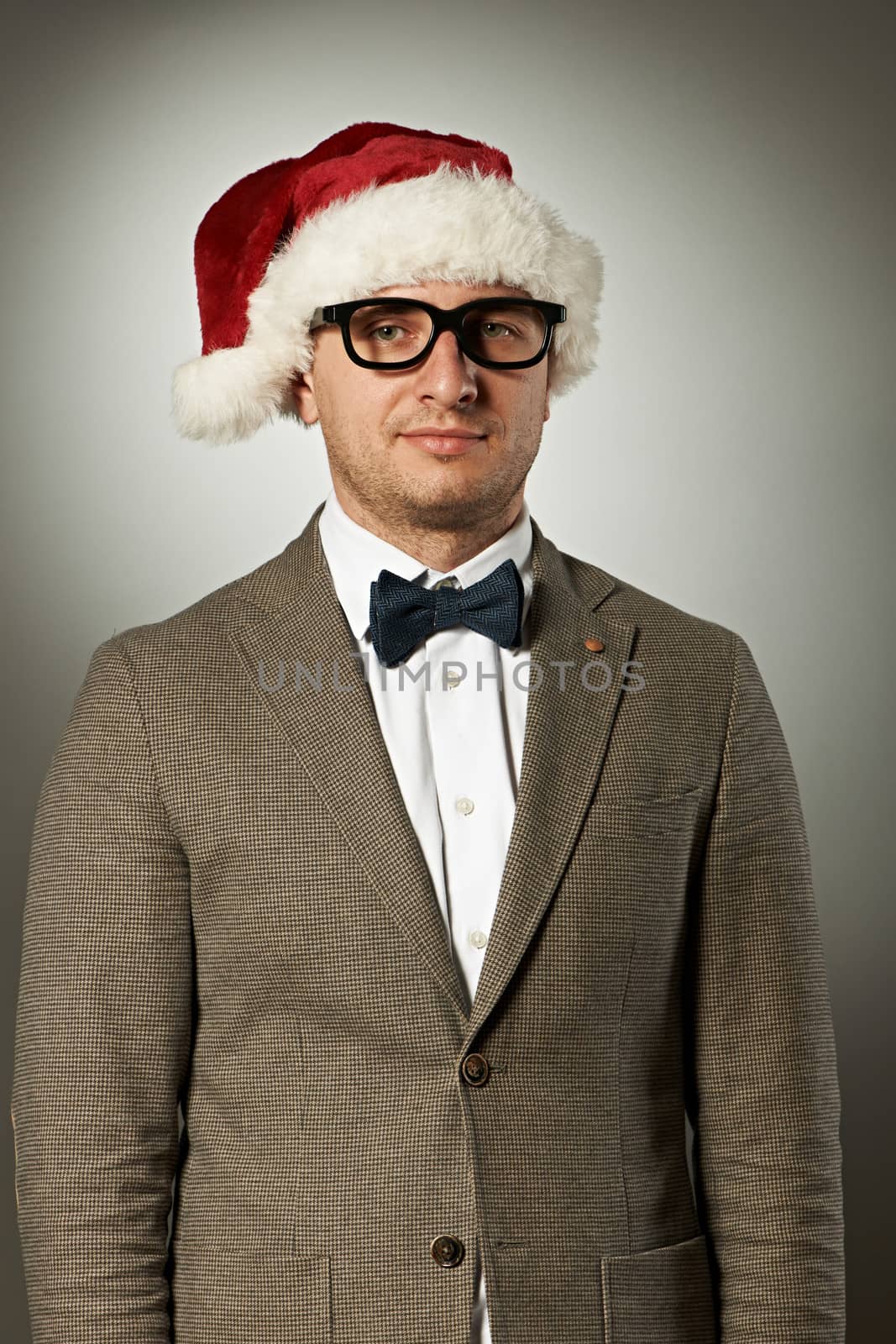 Confident nerd in Santa Claus hat and bow tie  by haveseen