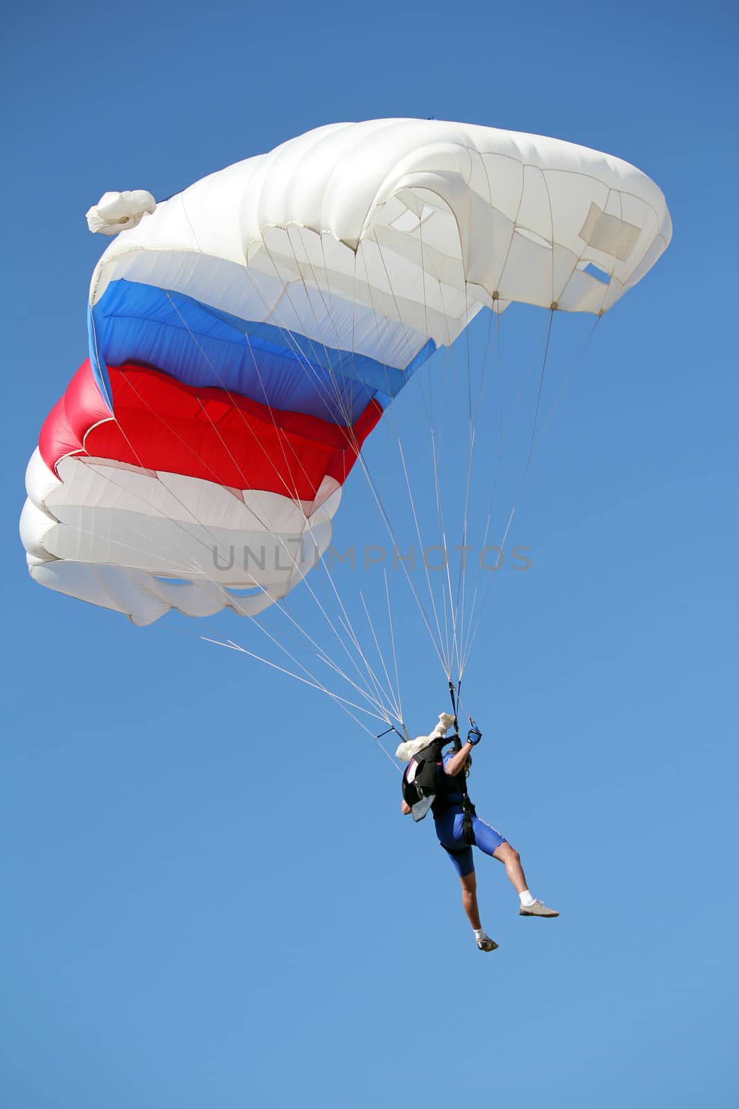 parachutist flying on blue sky