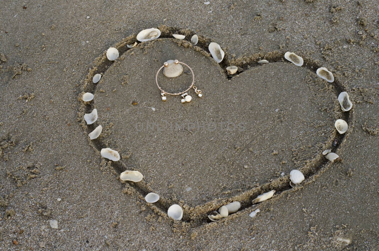 a heart on the sand in the beach by ammza12