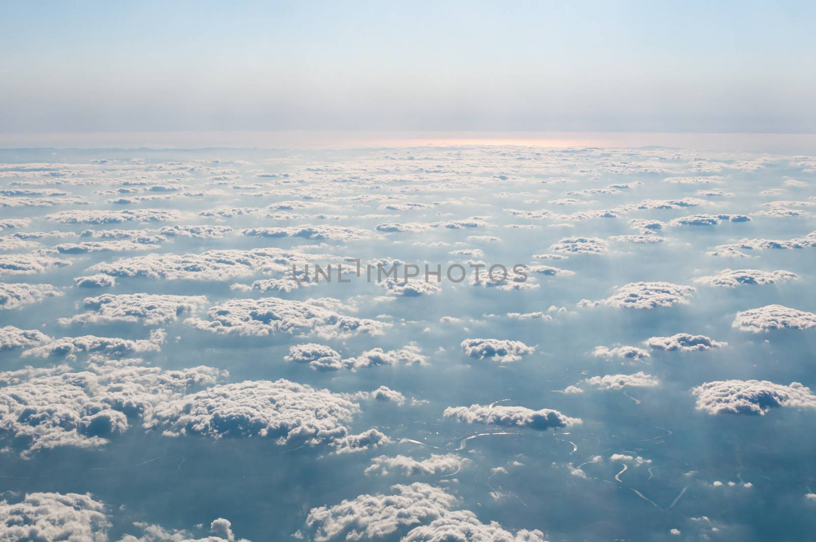 Aerial view of Alps above cloudscape, mountains and river