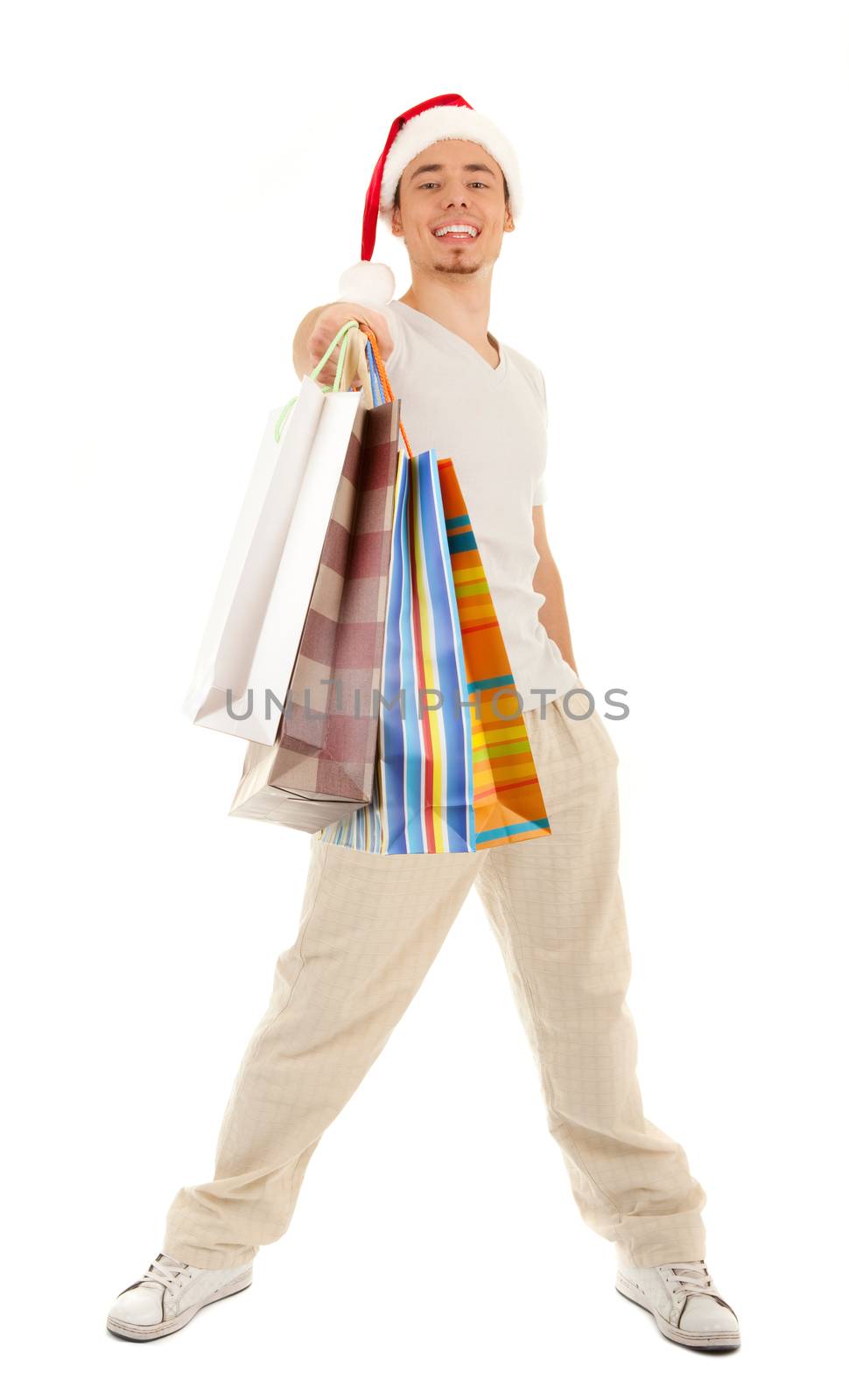 Young Santa with purchases in paper bags on white background