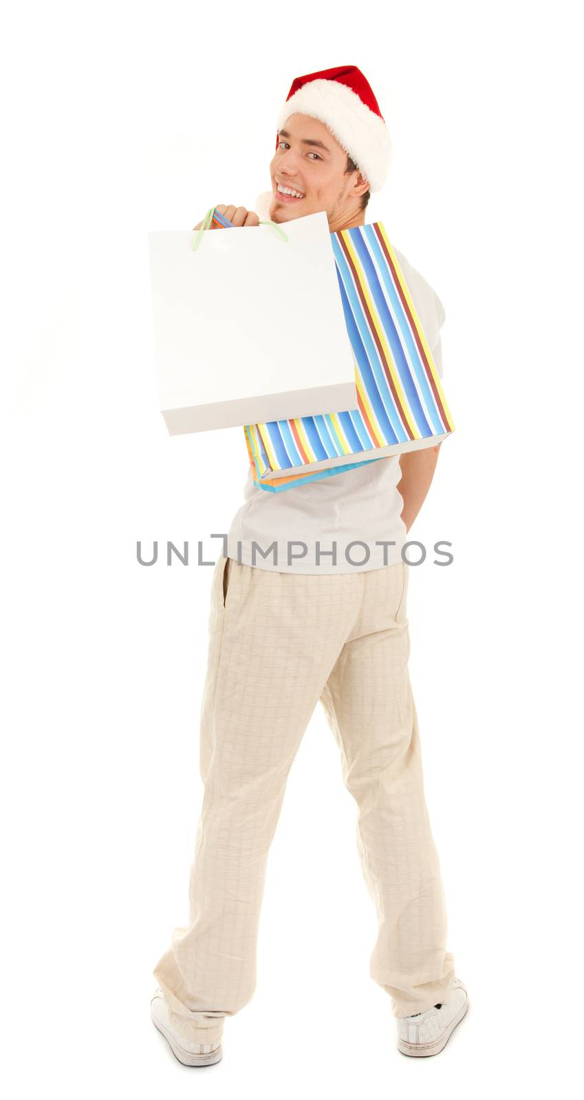 Young Santa with purchases in paper bags on white background