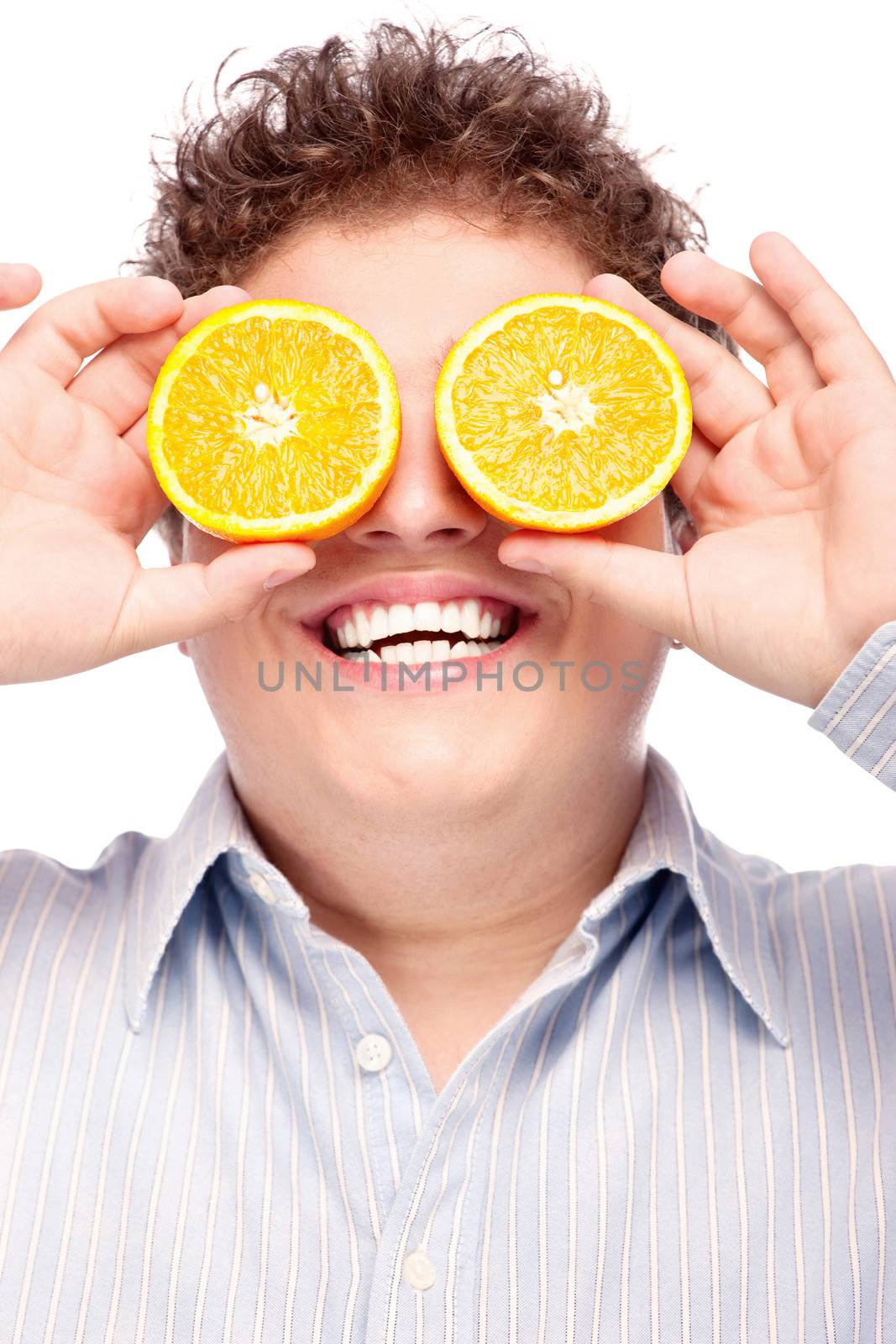 Happy man with slices of orange on his eyes, isolated on white background
