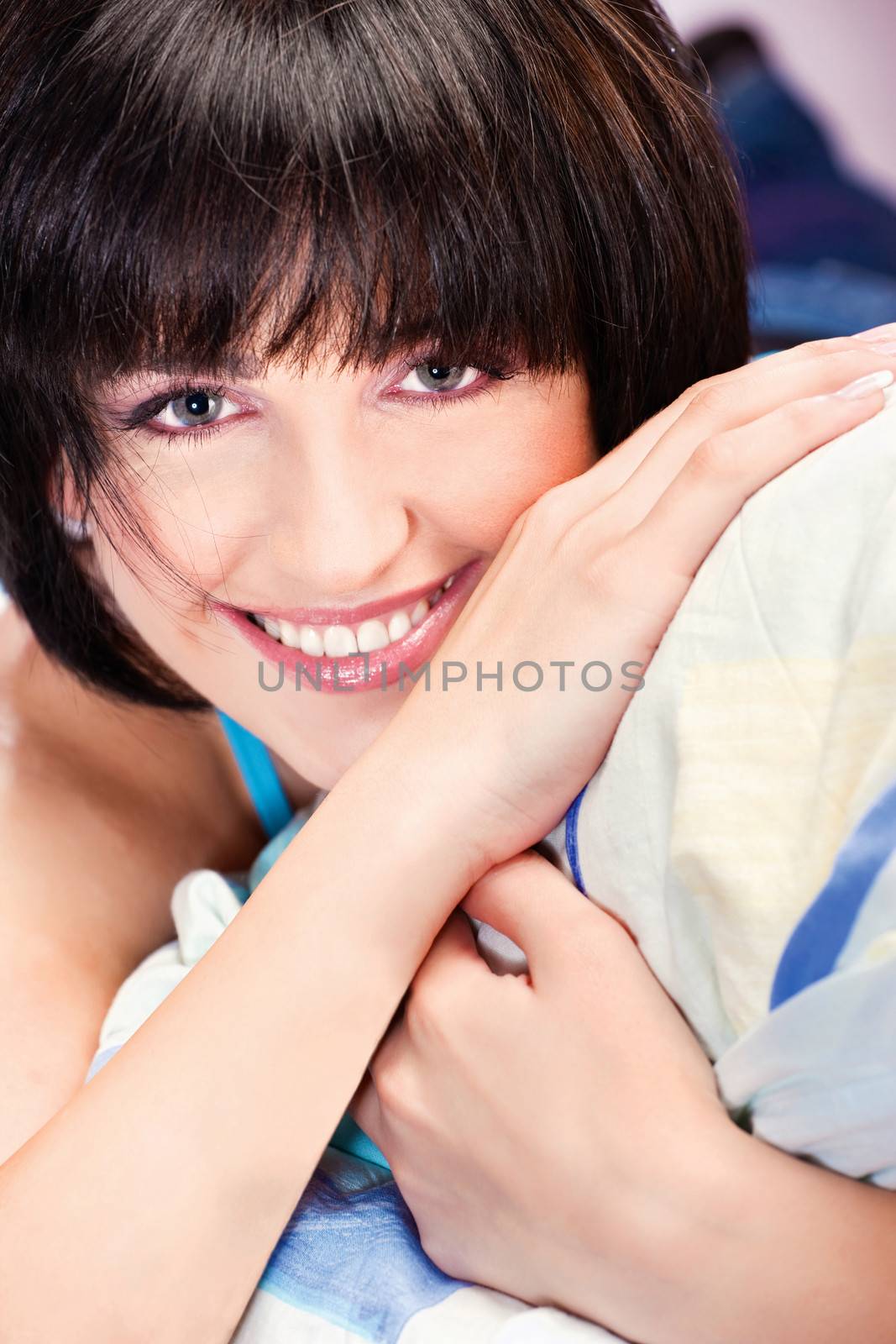 Cute smiling girl on pillow