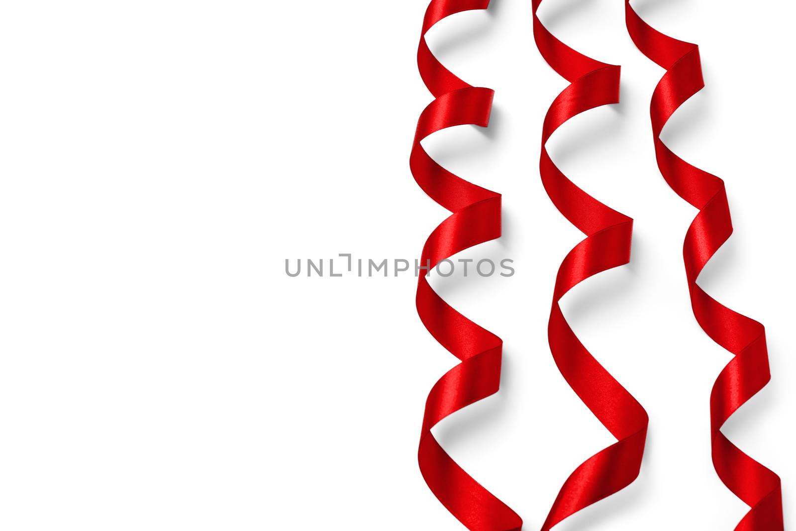 Shiny red satin ribbon on white background