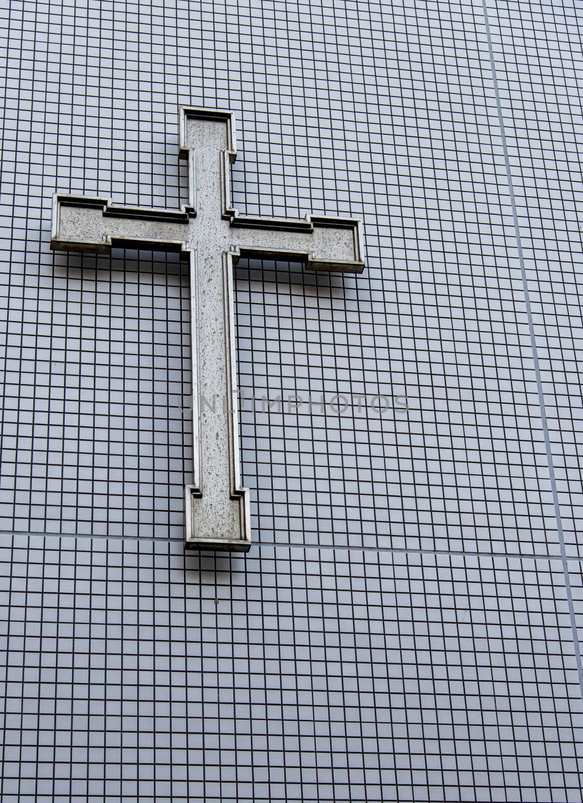 Cross on the wall by gjeerawut