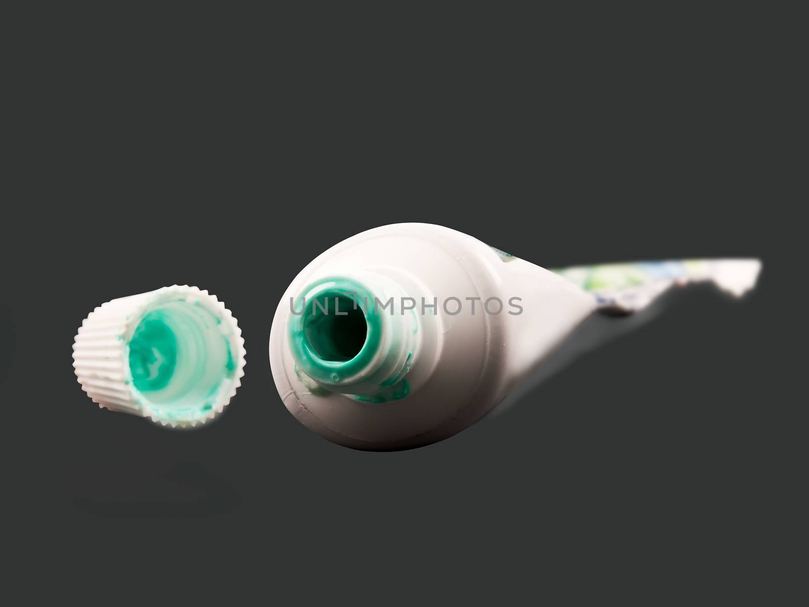 empty toothpaste on gray background