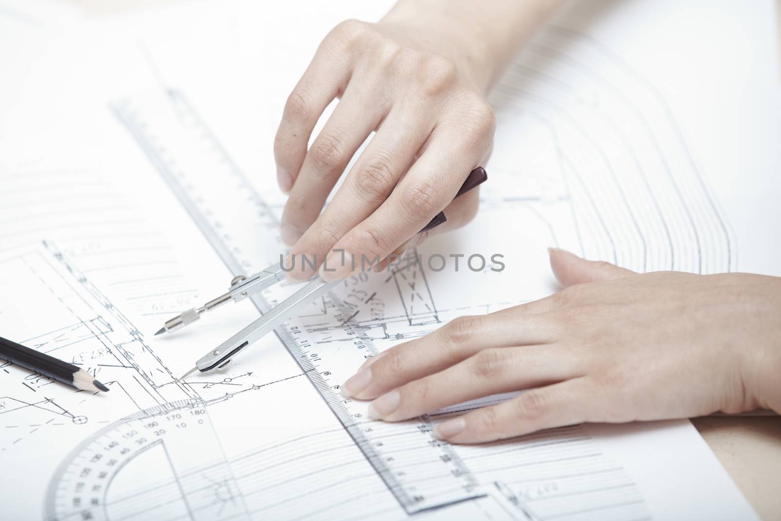 Hands of engineer working on a construction plan