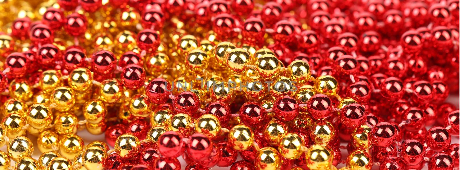 Closeup of gold and red beads. by indigolotos