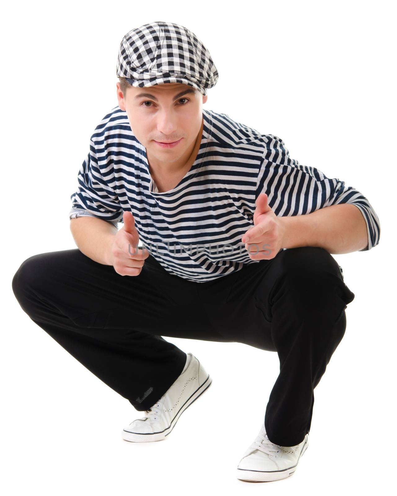 Thumbs up! by look naughty handsome young man in stylish striped dress and cap with suitcase