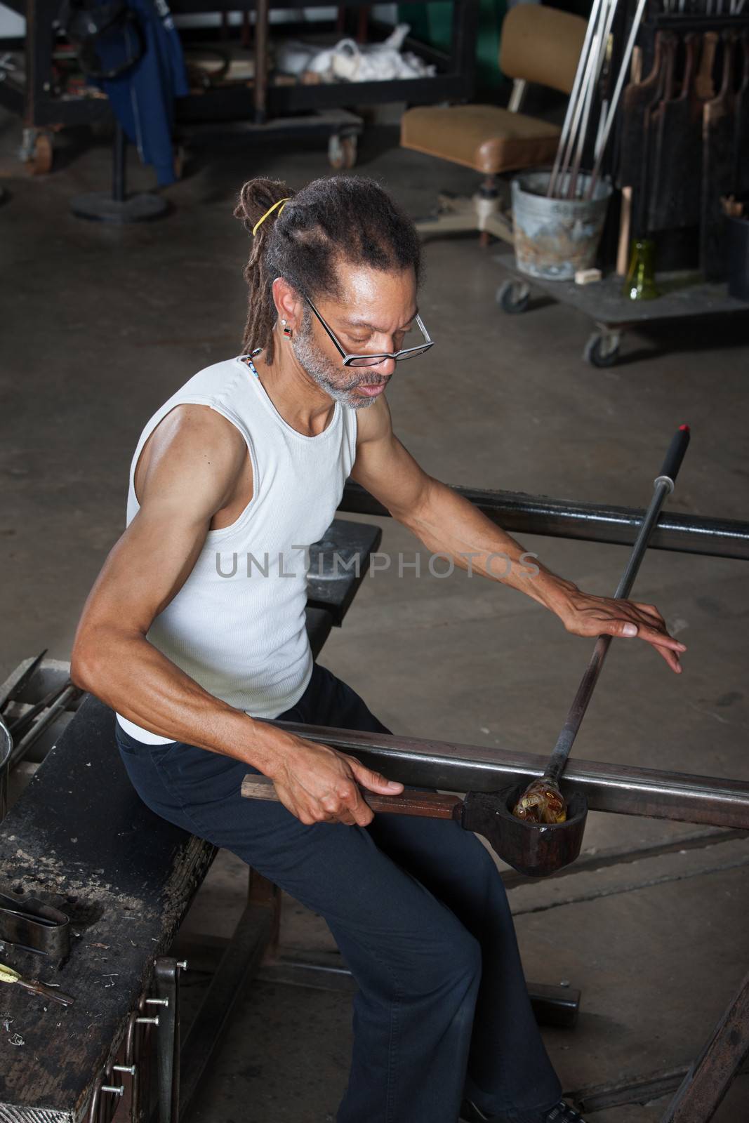Handsome Black man working on fine art glass jar