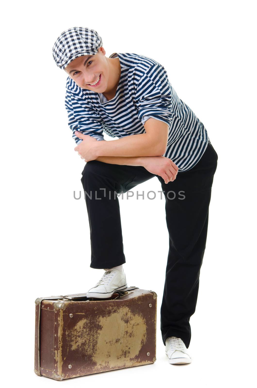 Look naughty handsome young man in stylish striped dress and cap with suitcase