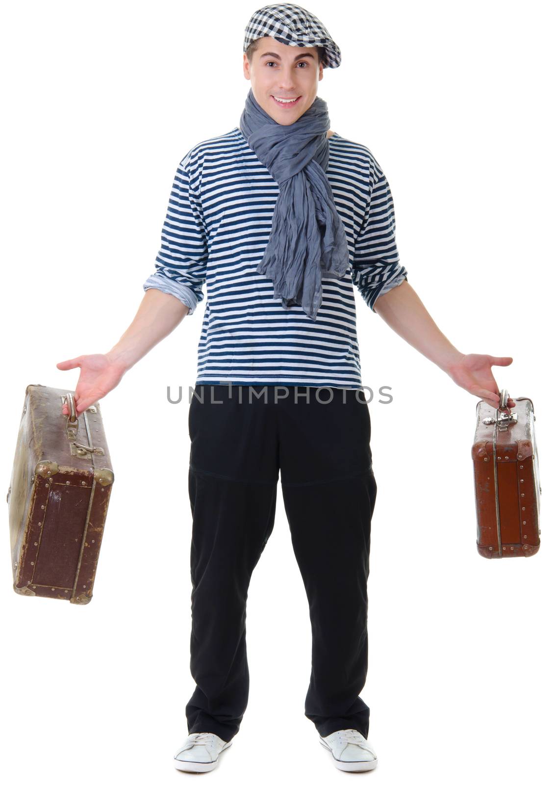 Look naughty handsome young man in stylish striped dress and cap with suitcases