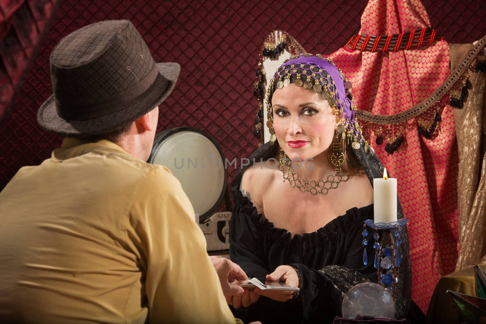 Sexy fortune teller with businessman and candle