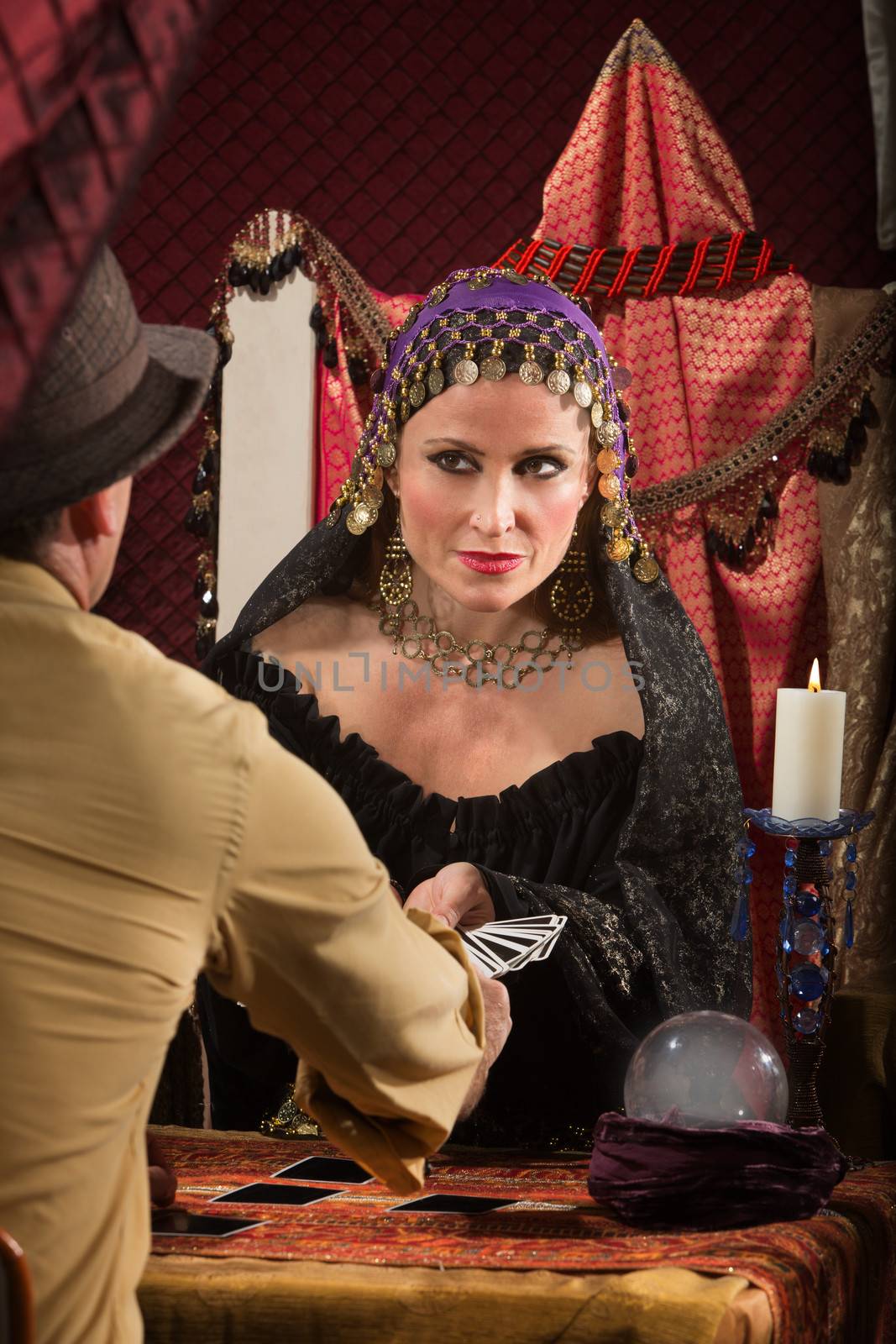 Charming fortune teller giving man a tarot card