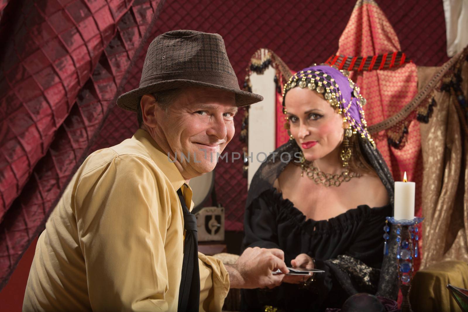 Lucky businessman taking tarot card from fortune teller