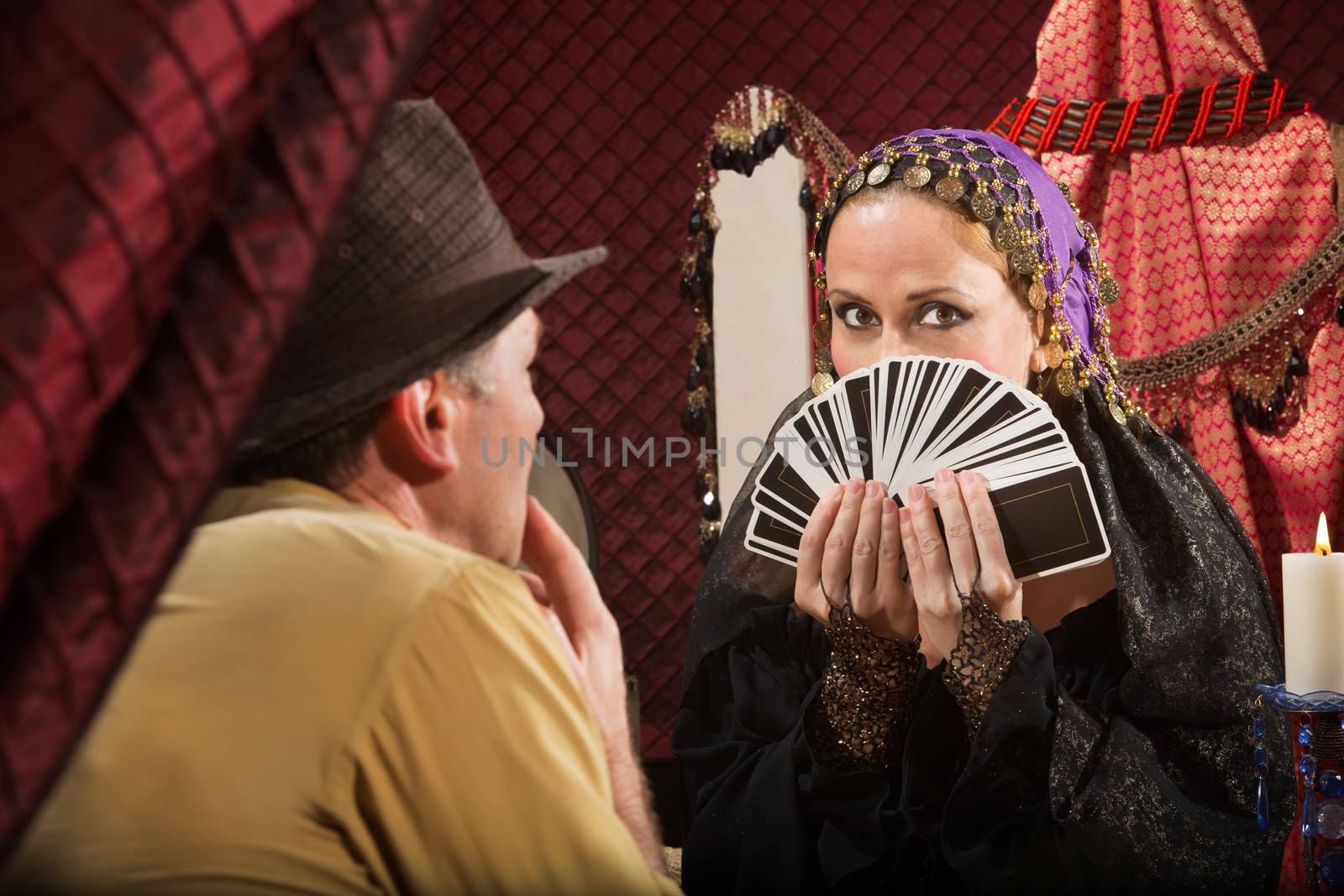 Attractive gypsy fortune partially covered by tarot cards