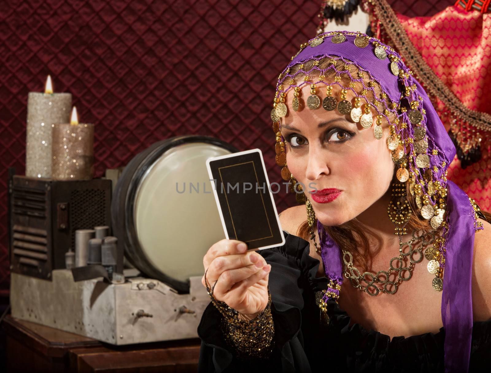 Cute fortune teller in ornate dress with tarot card