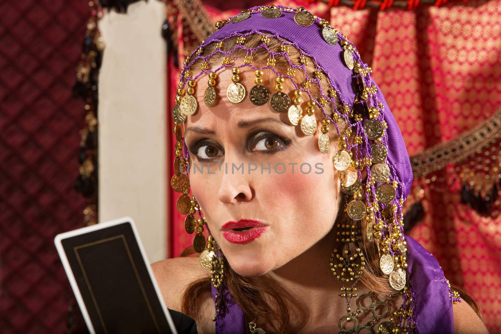 Worried European gypsy fortune teller with tarot card