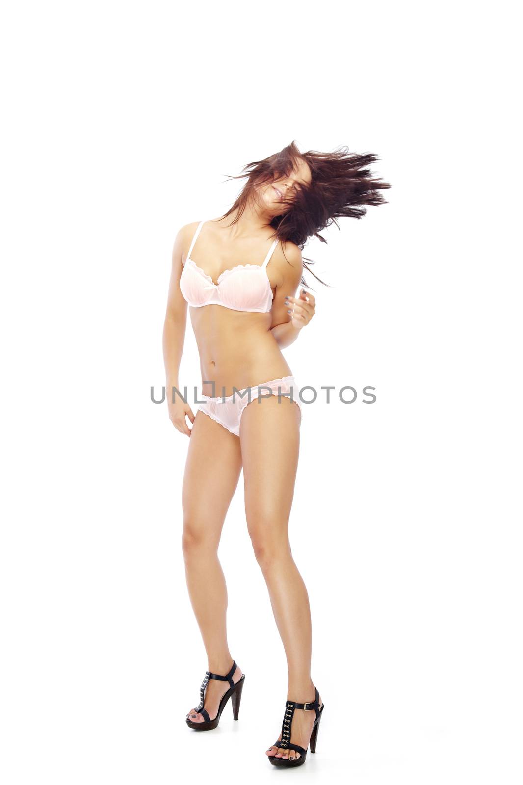 Young lady in lingerie dancing on a white background