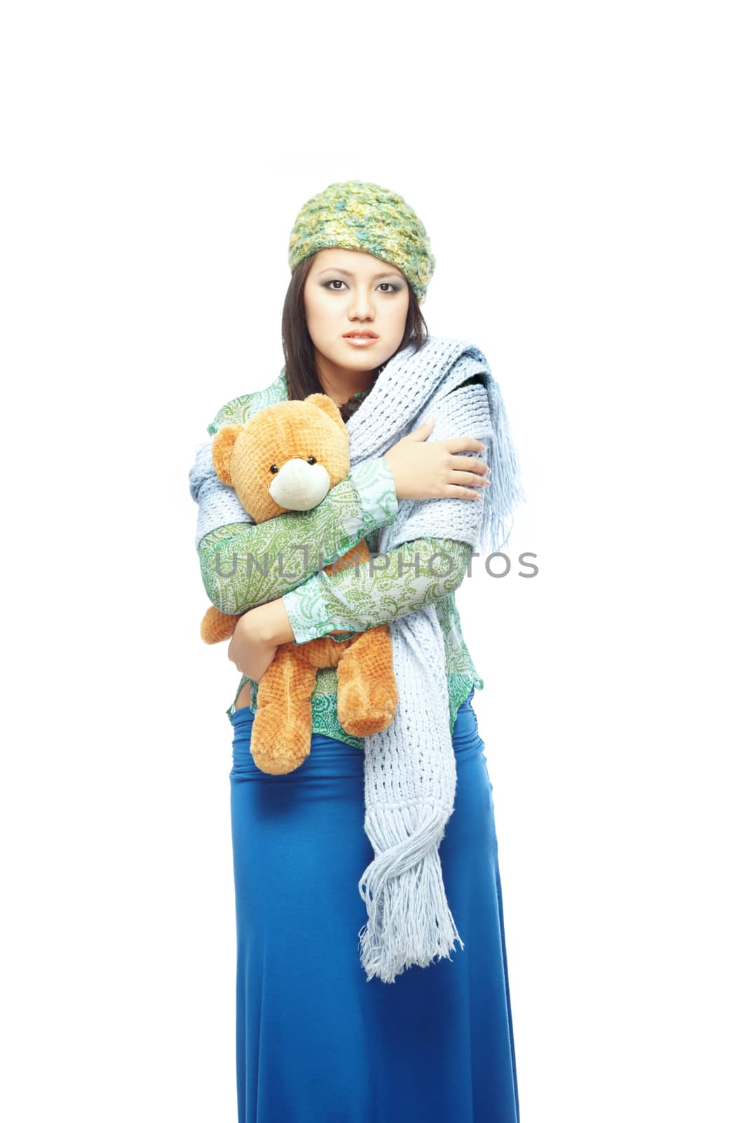 Sad young lady holding the toy on a white background