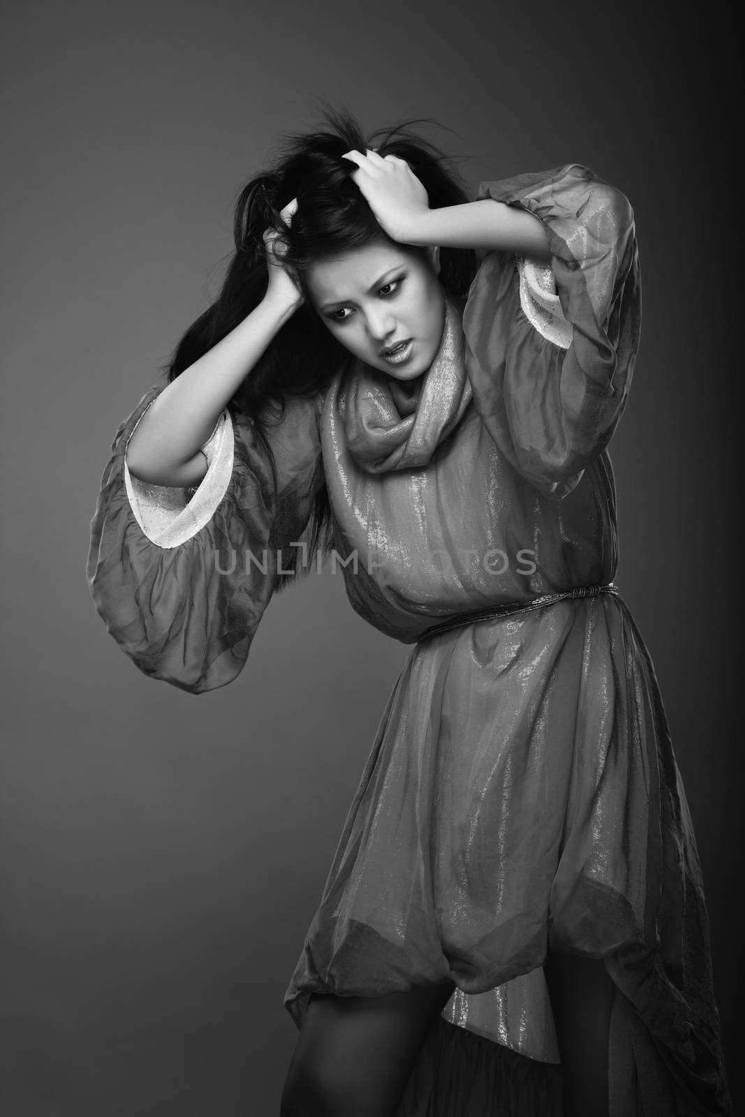 Lady in the studio suffering from the headache and depressive insomnia. Black and white photo