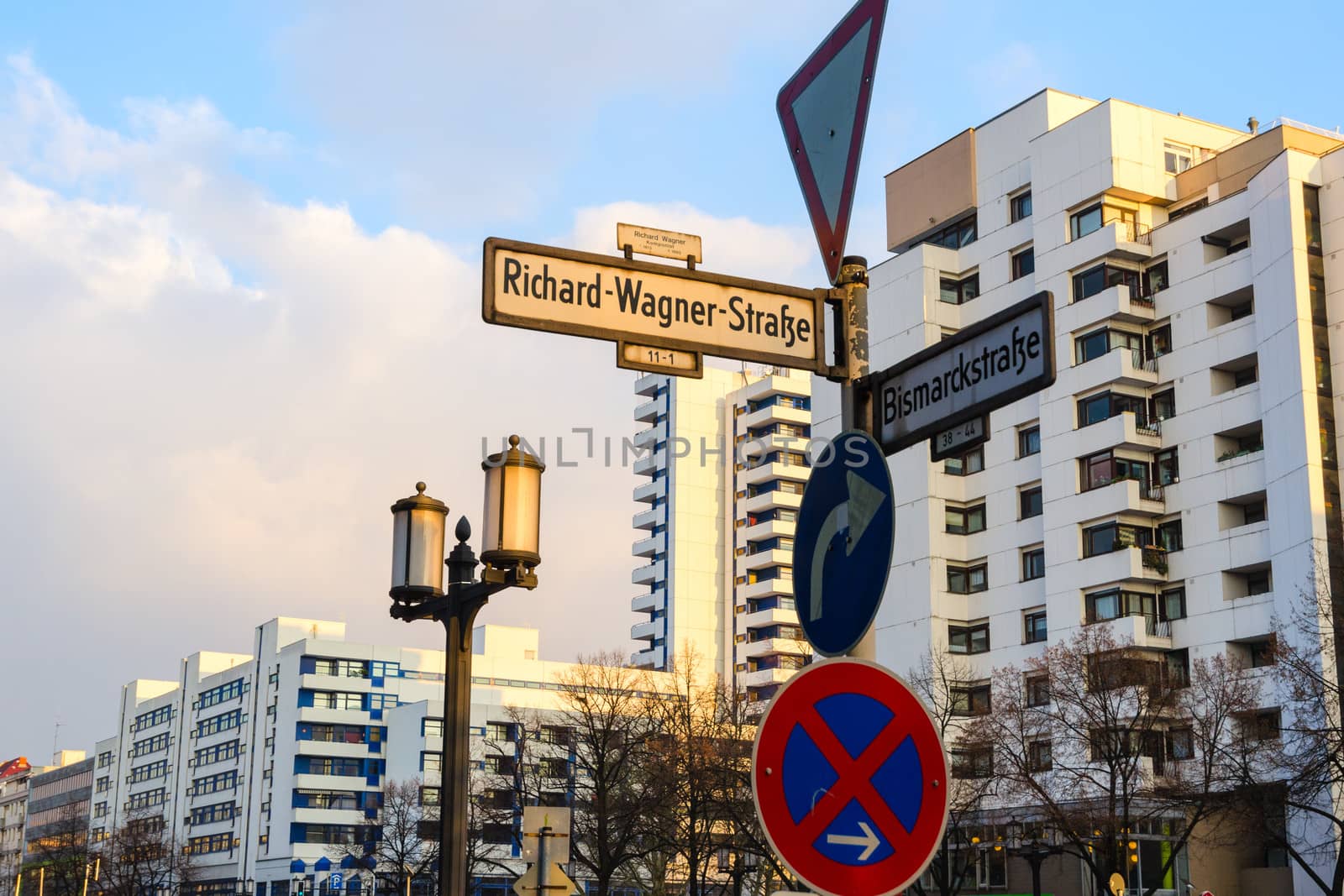 Signpost with waymark in sleeping quarter of evening lighted Berlin