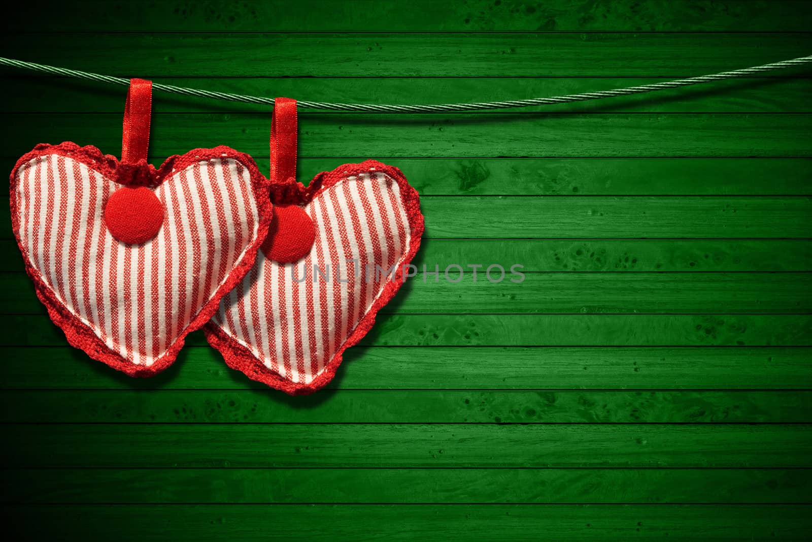 Red Cloth Hearts on Green Wood Background by catalby