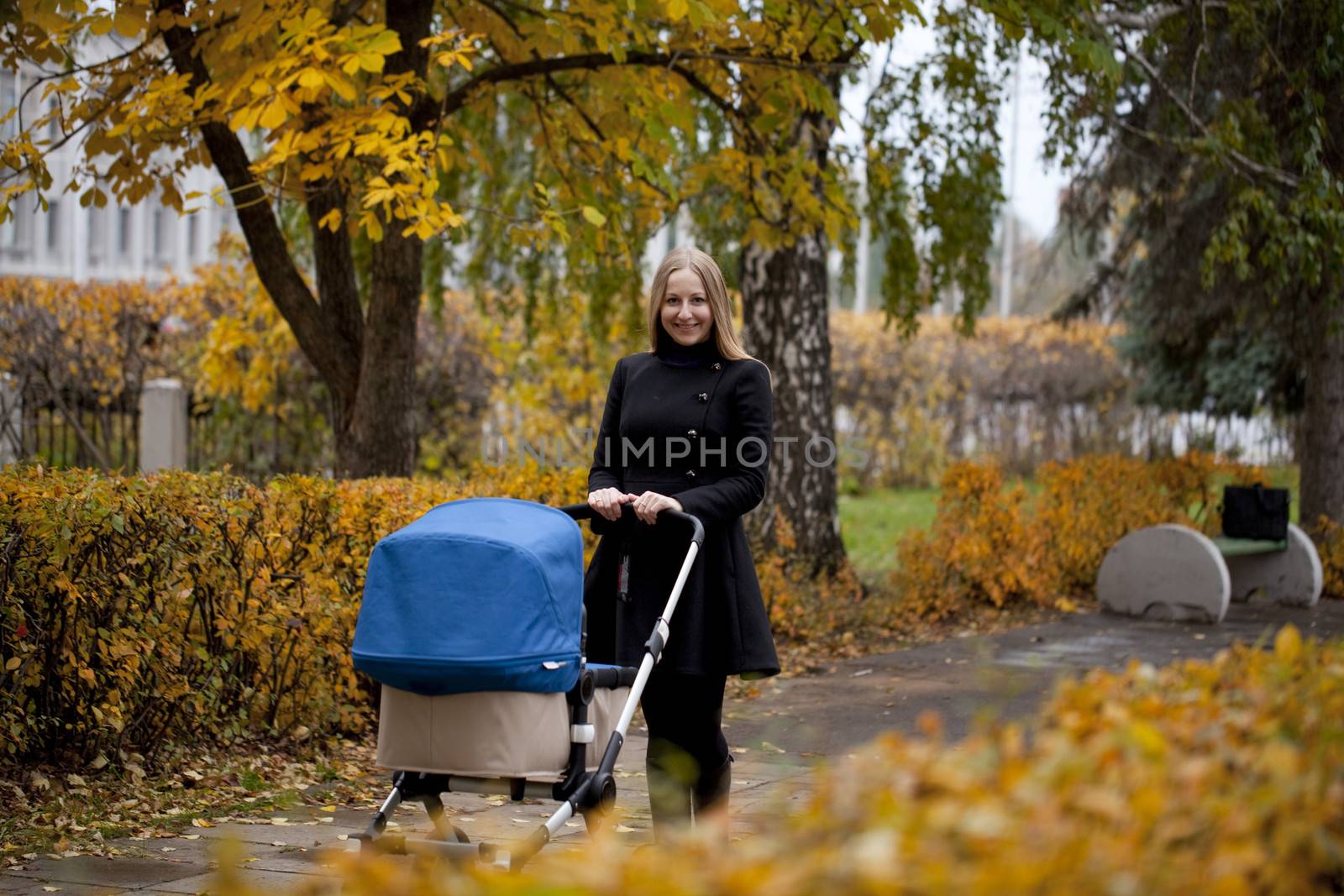 Mother with baby stroller for a newborn by andersonrise