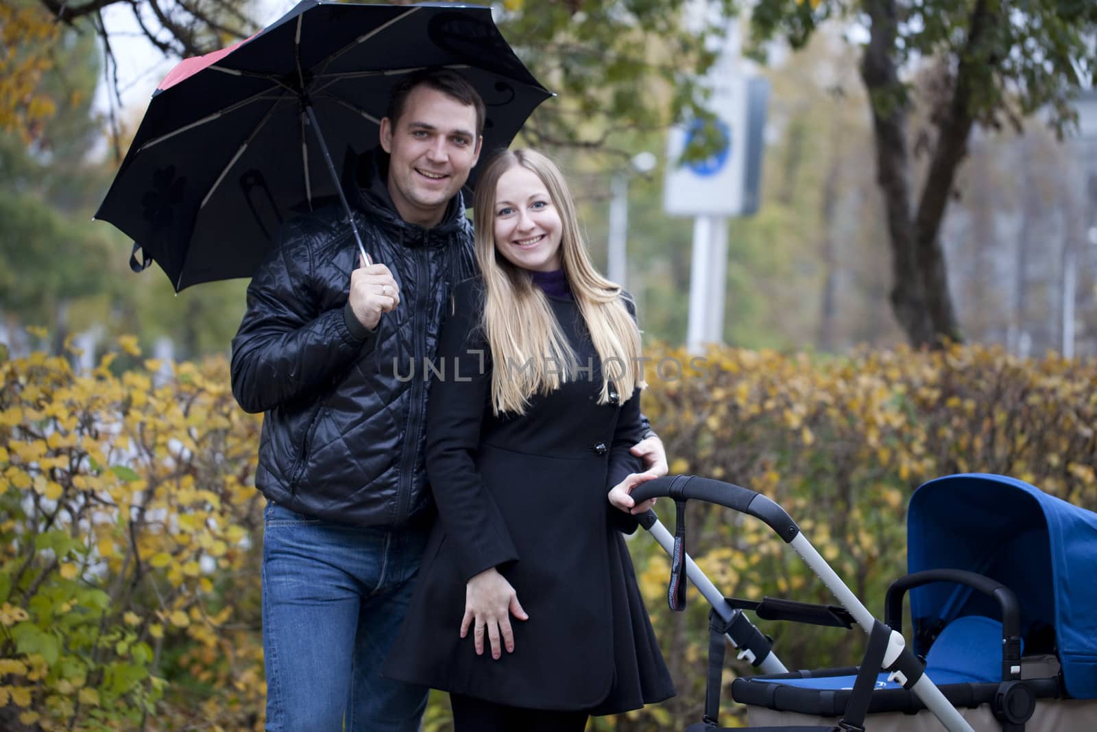 Happy young family in autumn park