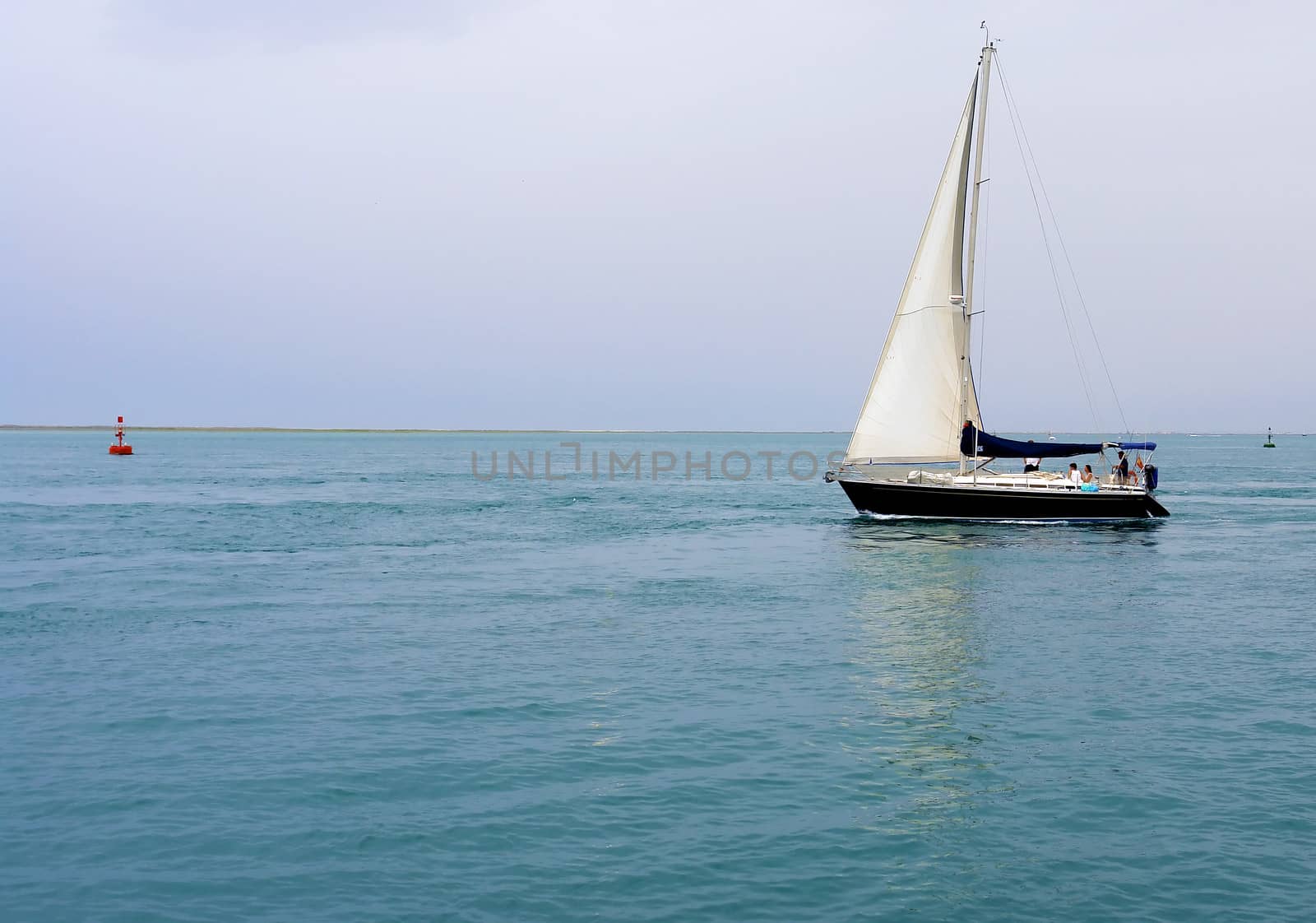 Recreation boat at sunset, in Ria Formosa, natural conservation region in Algarve, Portugal. 