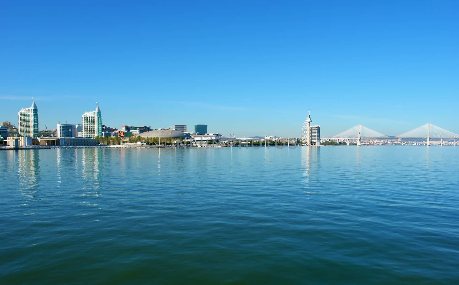 View from river Tagus of Lisbon's Nations park and "Vasco da Gama" Bridge, Portugal                           